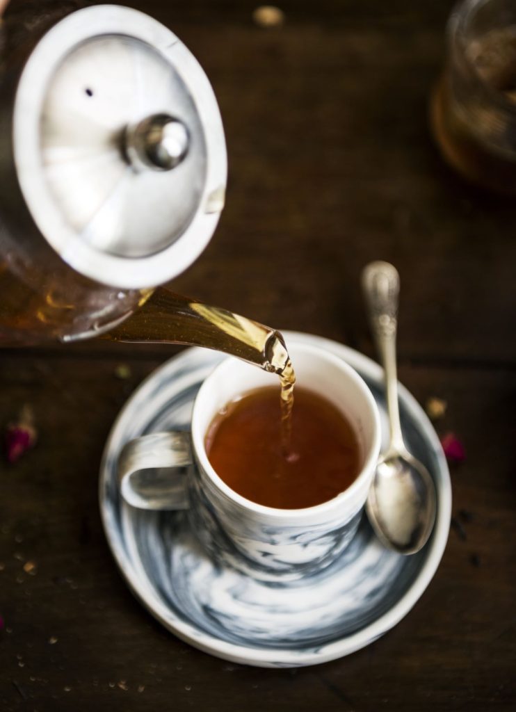 tea being poured in a cup