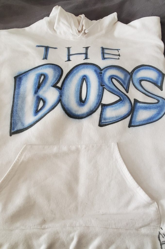 hoodie with "The Boss" airbrushed across the center